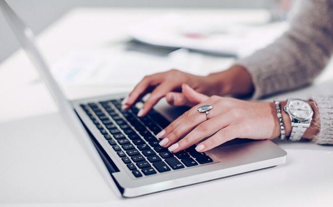 A Person Typing on a Computer and Doing Paid Surveys