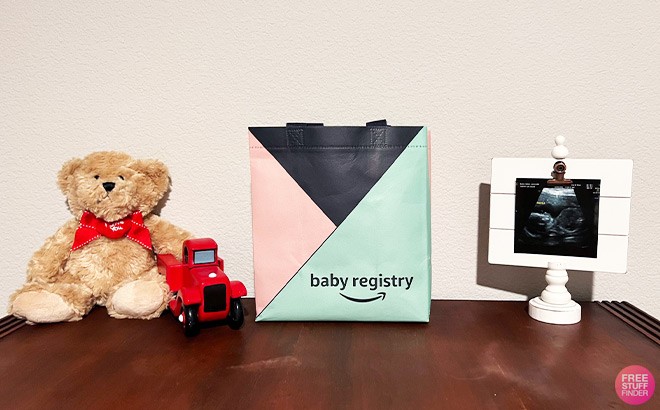 Teddy Bear, Baby X Ray and an Amazon Baby Welcome Bag on a Table Top