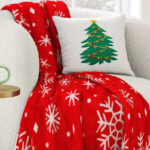 Holiday Printed Snowflake Red Plush Throw Blanket on an Armchair