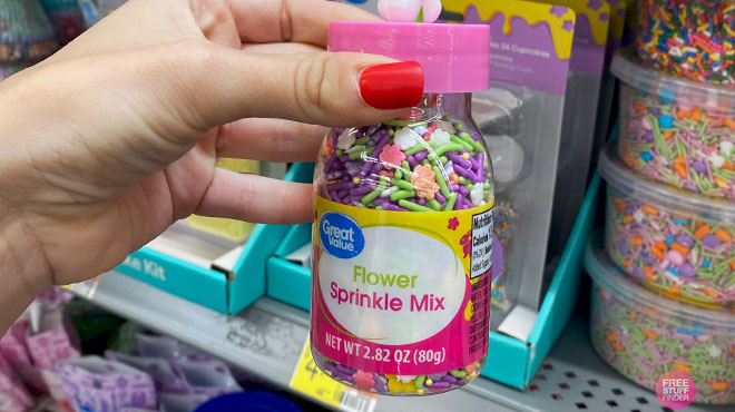 Hand Holding a Great Value Flower Sprinkles Mix if Front of the Store Shelf