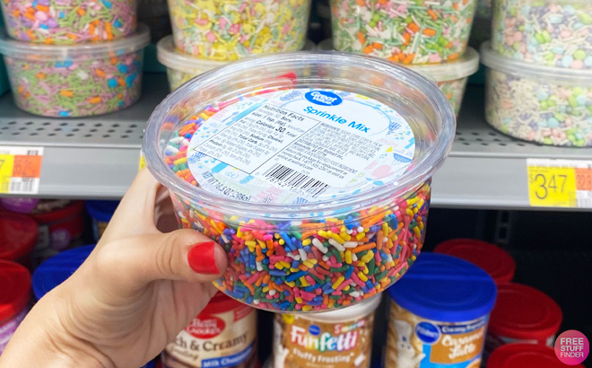 Hand Holding a Great Value Spring Sprinkles Tub in Front of the Store Shelf