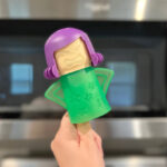 Hand Holding Angry Mama Microwave Cleaner in Green Color