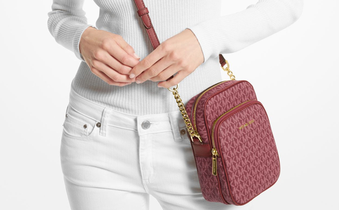 Model Wearing Michael Kors Jet Set Travel Medium Logo Crossbody Bag in Mulberry Color