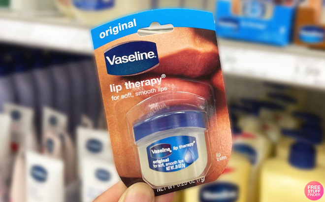 Woman holding a Vaseline Lip Therapy Mini at the Store