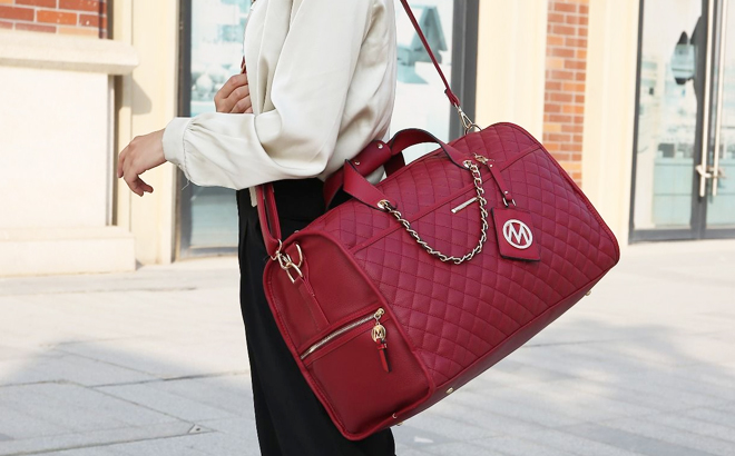 Woman Wearing MKF Vegan Leather Duffle Handbag in Red Color