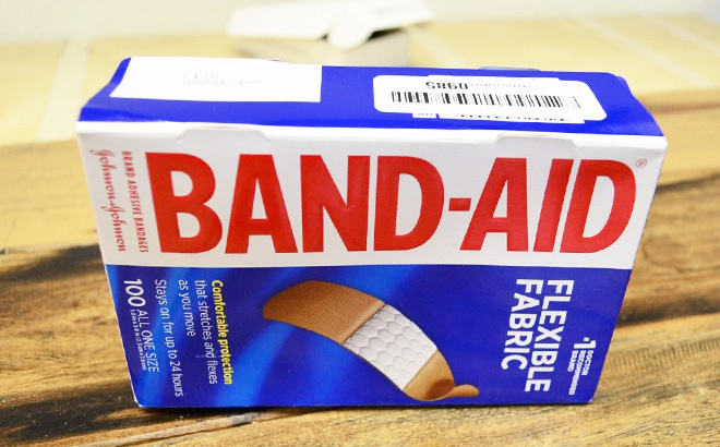 A 100 Count Pack of Band Aid Adhesive Bandages on a Table