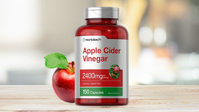 A Bottle of 150 Count Apple Cider Vinegar Capsules 2400mg with an Apple on a Table