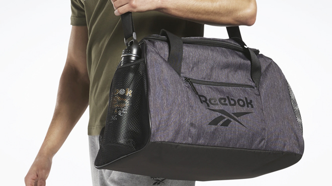 A Man Carrying Reebok Workout Duffel Bag