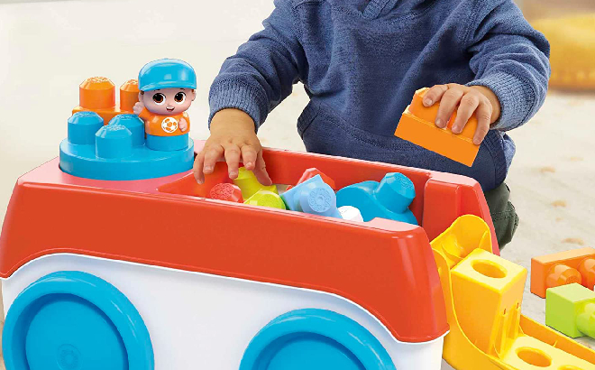 Baby Playing woth Fisher Price Spinning Wagon Building Blocks Set