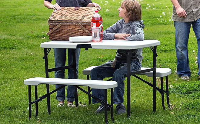 Boy sitting on Lifetime Portable Folding Picnic Table Bench Set