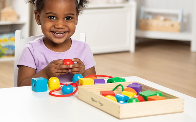 Child Playing With Melissa And Doug Wooden Beads Toy