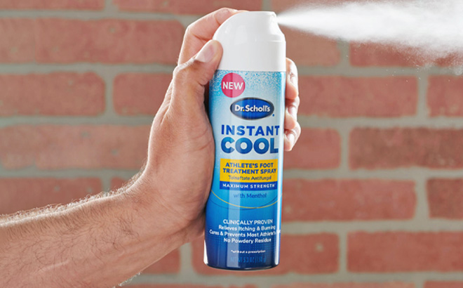 Man Holding a Dr. Scholl's Instant Cool Foot Spray