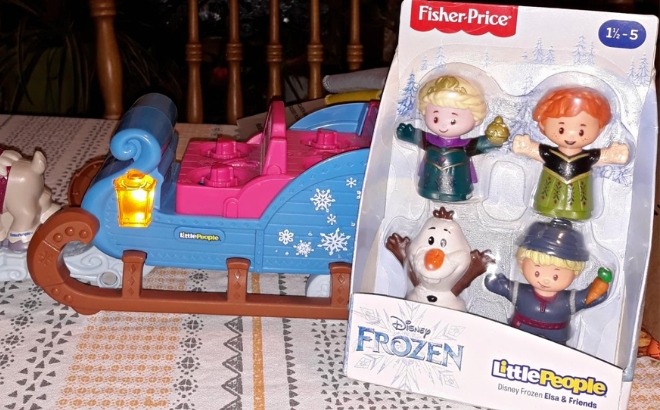 Fisher Price Disney Frozen Elsa Friends by Little People 4 Pack Box in Front of a Toy Sleigh