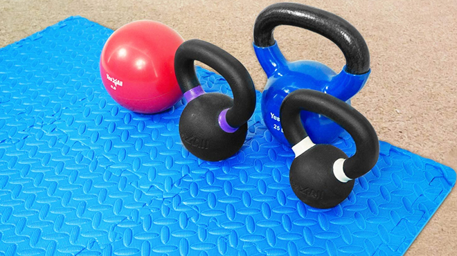 Four Workout Equipments on a Blue Exercise Mat