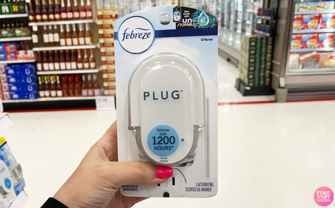 Hand Holding Febreze Plug Warmer