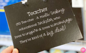 Hand Holding Teacher Dictionary Explanation Sign at Target