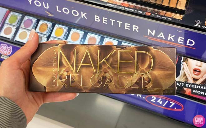 Hand Holding Urban Decay Naked Reloaded Eyeshadow Palette Inside a Store