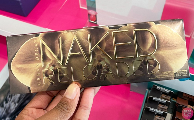 Hand Holding Urban Decay Naked Reloaded Eyeshadow Palette