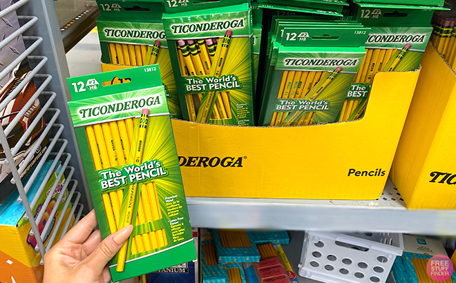 Hand holding one Ticonderoga Wood Cased Pencils and more packs in shelf