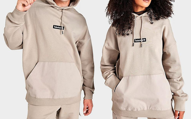 Man and Woman Wearing Timberland Cargo Pullover Hoodie in Pure Cashmere Color