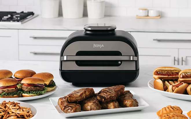 Ninja Foodi 6 in 1 Smart XL Indoor Grill and Air Fryer with Various Cooked Meals on a Marble Kitchen Countertop