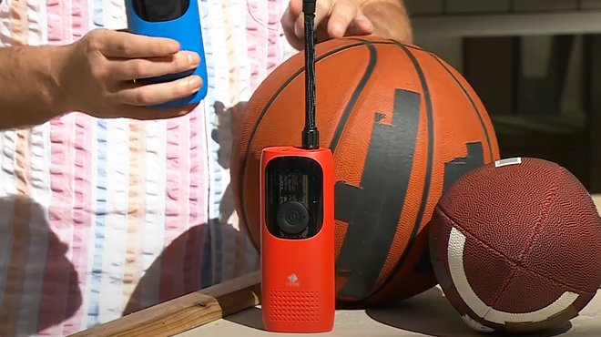 Red Z Edge Portable Air Inflator on a Desk with Basketball and Football