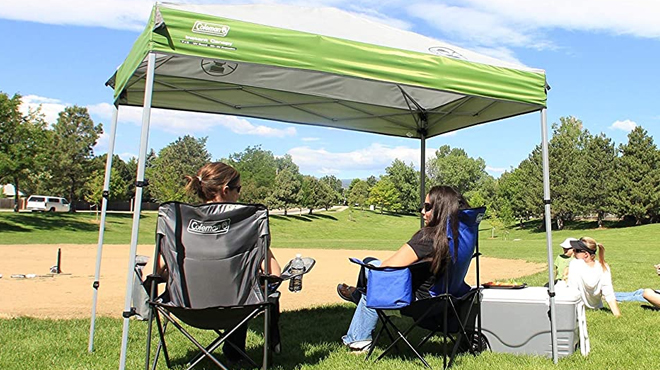 Two Women Under Coleman 10x10 Instant Canopy in Green Color on a Park