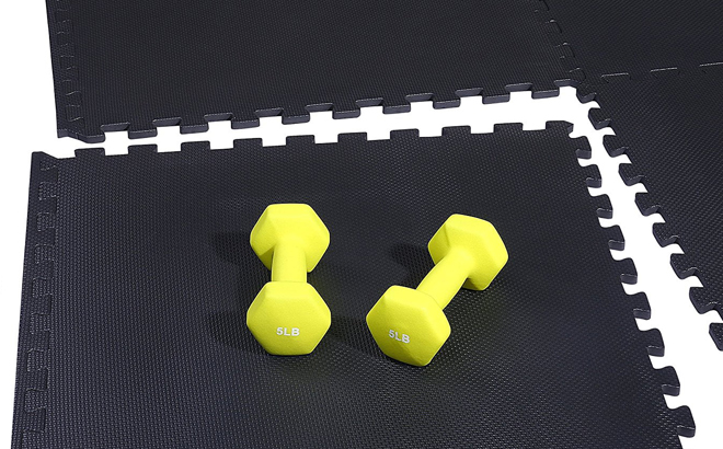 Two Yellow Dumbbells on a Black Exercise Foam Mat Puzzle