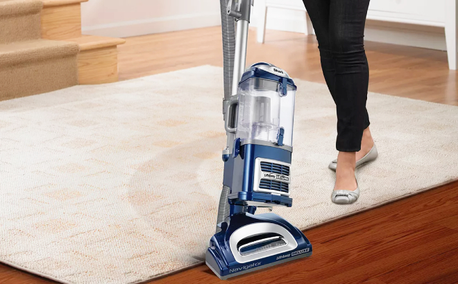 Woman Using Shark Navigator Vacuum to Clean a Carpet