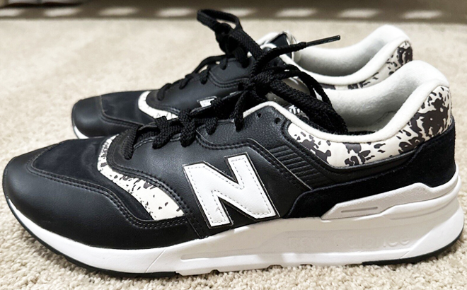 a Pair of Womens New Balance 997H on White Floor Carpet