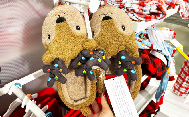 a Person Holding Wondershop Adult Holiday Light up Reindeer Slippers