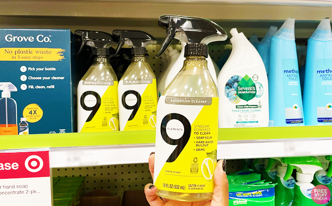 a Person Holding a 9 Elements 18 Ounce Bath Spray All or Purpose Cleaner in a Store