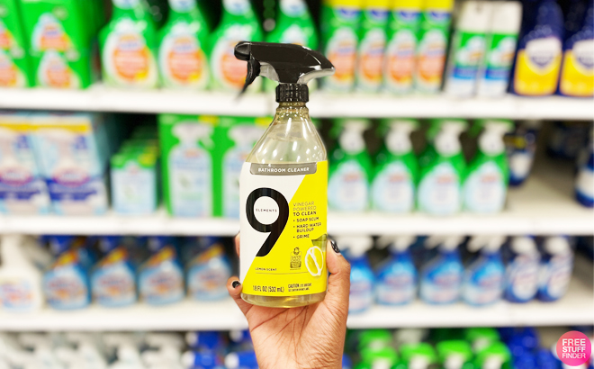 a Person Holding a Bottle of 9 Elements Bath Spray inside a Store