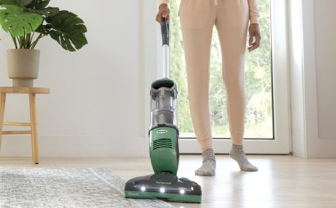 a Person Using a Shark Freestyle Pro Cordless Vacuum with Precision Charging Dock Model SV1114