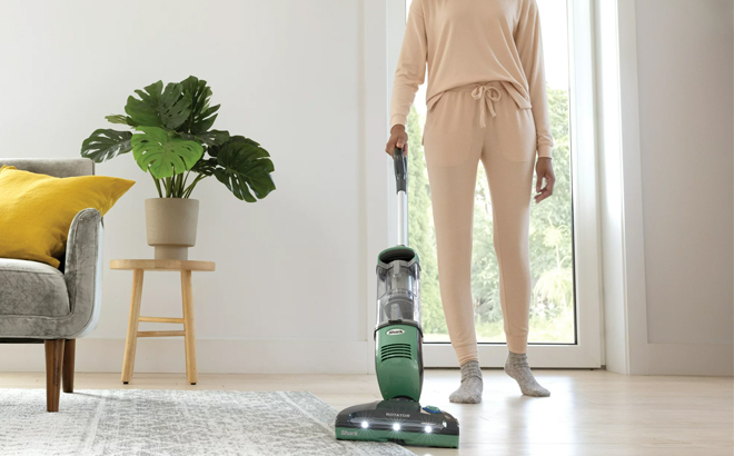 a Person Using a Shark Freestyle Pro Cordless Vacuum