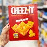 A Hand Holding Cheeze It Cracker Box in Walgreens Aisle