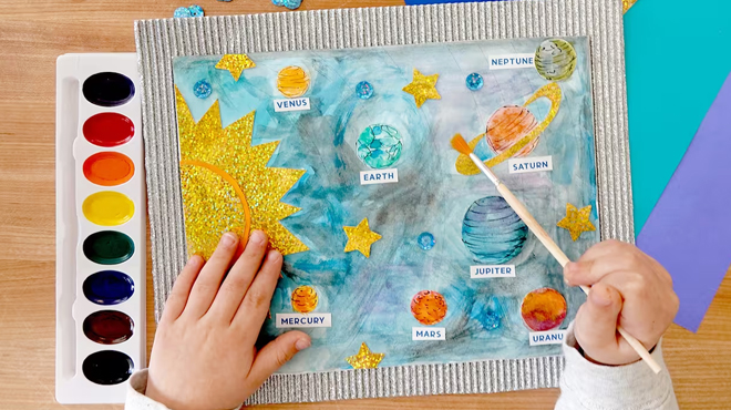 A Kid Using Creatology Space Collage Kit