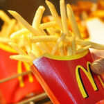 Person Holding McDonalds Large Fries