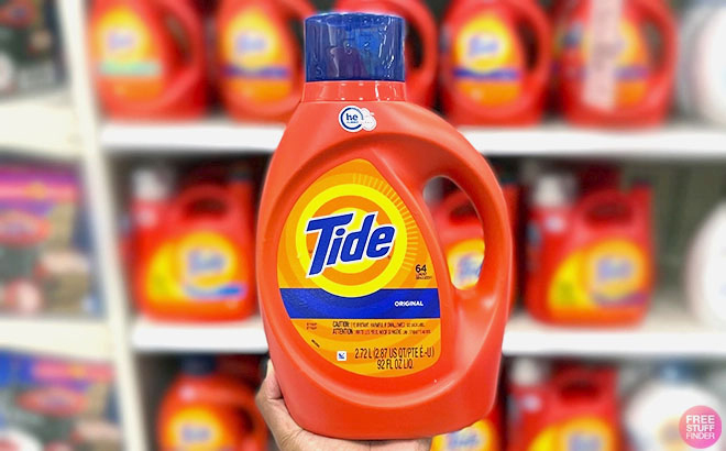 Person Holding Tide Liquid Laundry Detergent 64 Loads at CVS