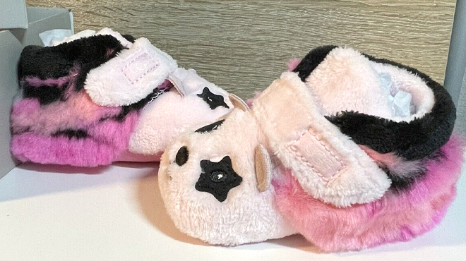 UGG Bixbee Panda Stuffie Baby Booties on a Table