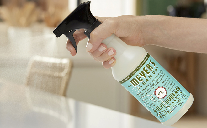 Woman Spraying with Mrs Meyers All Purpose Cleaner with Basil Scent