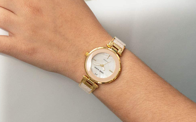 Woman Wearing Anne Klein Genuine Diamond Dial Bangle Watch in Pink and Gold Color
