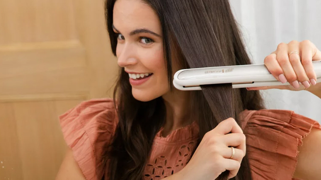 A lady using a Remington Keratin Infused Flat Iron