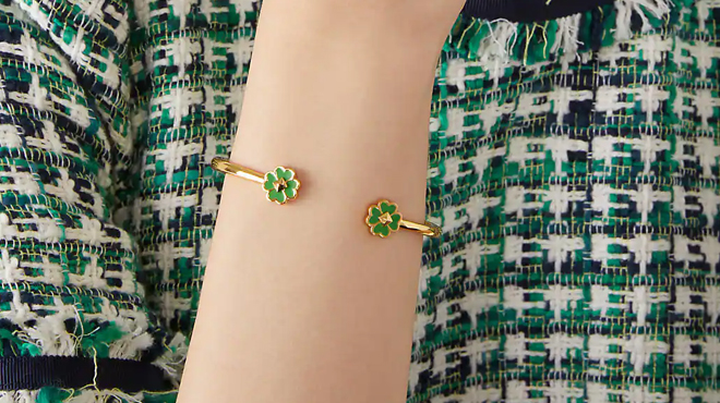 A person wearing a Kate Spade Spades Studs Hinge Cuff