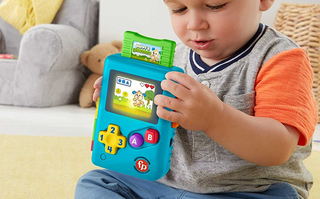 Baby Holding Fisher Price Lil Gamer Pretend Video Game