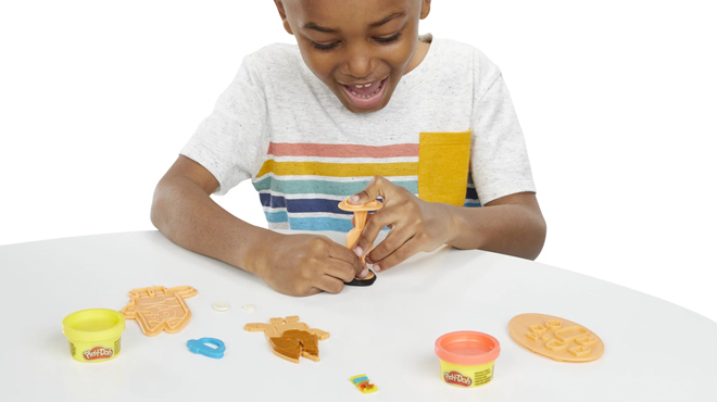 Boy Playing with Play Doh Bluey Make n Mash Costumes Playset