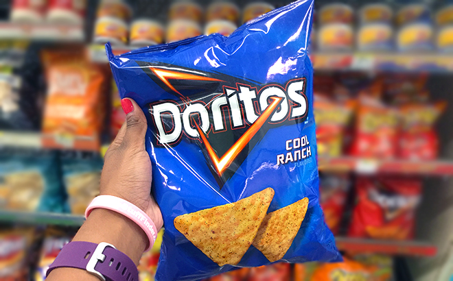 Hand holding one Doritos Cool Ranch Chips