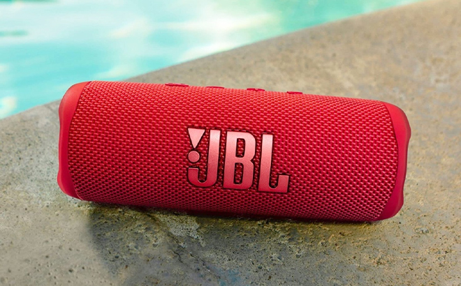 JBL Flip 6 Portable Waterproof Bluetooth Speaker Next to a Pool