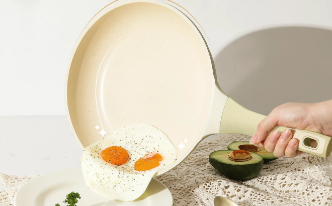 Lady Transferring a Cooked Egg on a Plate Using Her Carote Skillet