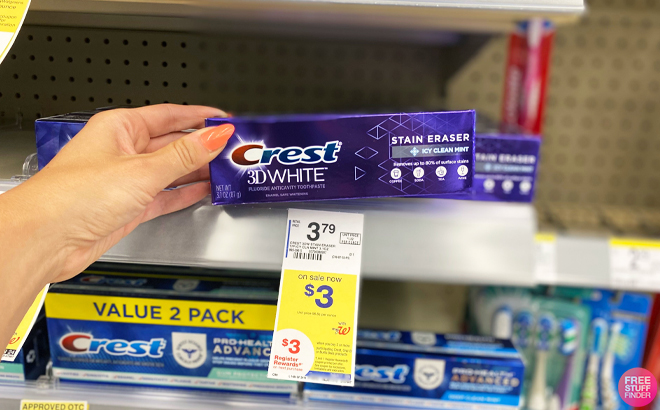 Person Checking out a Crest Stain Eraser Toothpaste